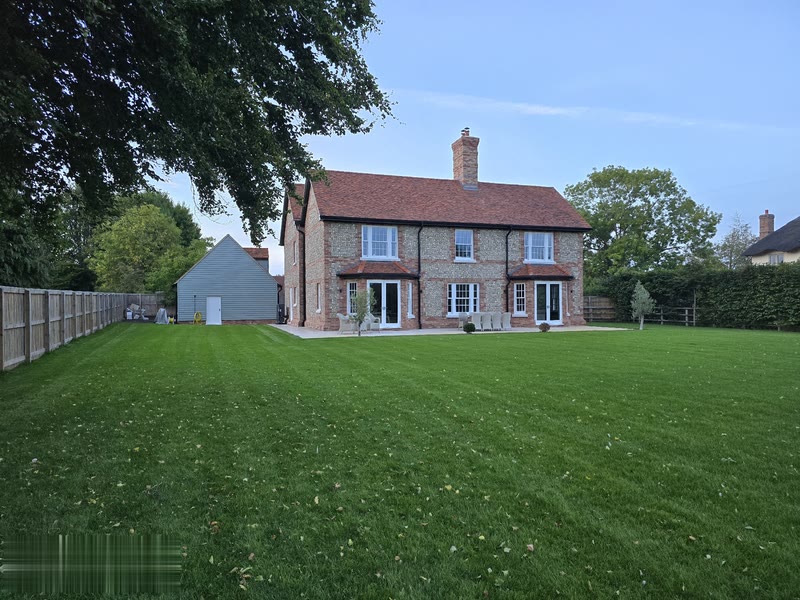 Rear garden elevation — full back of the house with French doors onto the patio