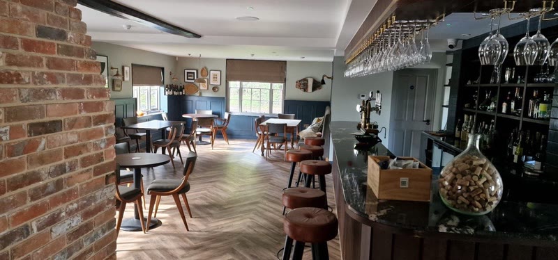 Exposed brick arch between dining room and bar
