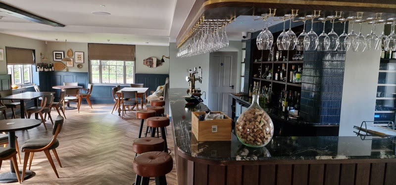 Long dining room view with restored timber beams